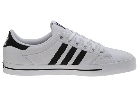 white adidas shoes black stripes.